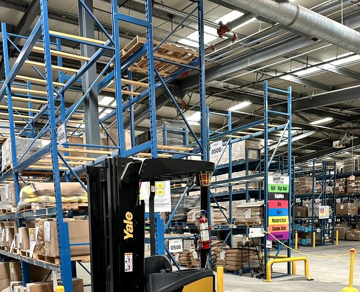 Warehouse racking and a forklift in a distribution center