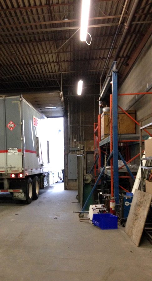 A truck backing into a busy service bay
