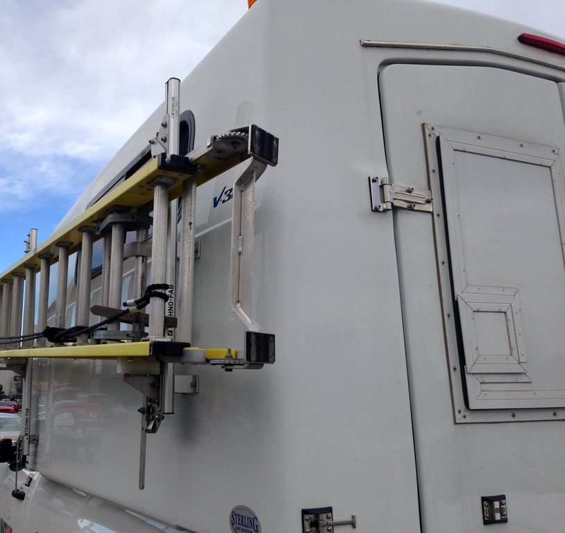 Service truck with a ladder rack in a parking lot