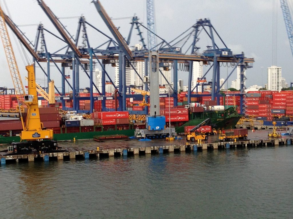 Cranes loading shipping containers at a busy port
